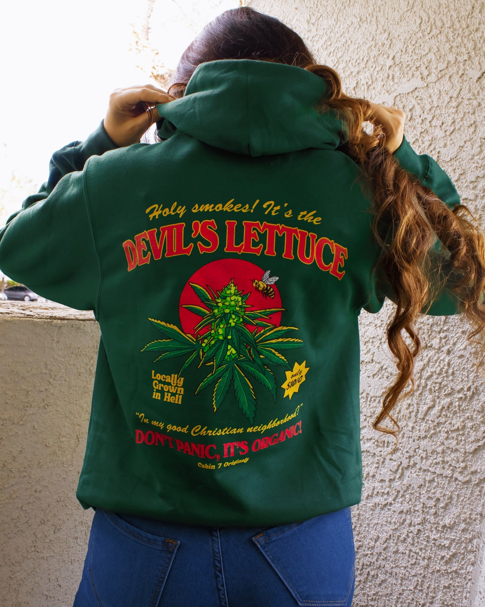 A dark green hoodie with a bright red and gold design of a cannabis plant that says "Devil's Lettuce". Hippie hoodie, 420 hoodie, stoner hoodie.