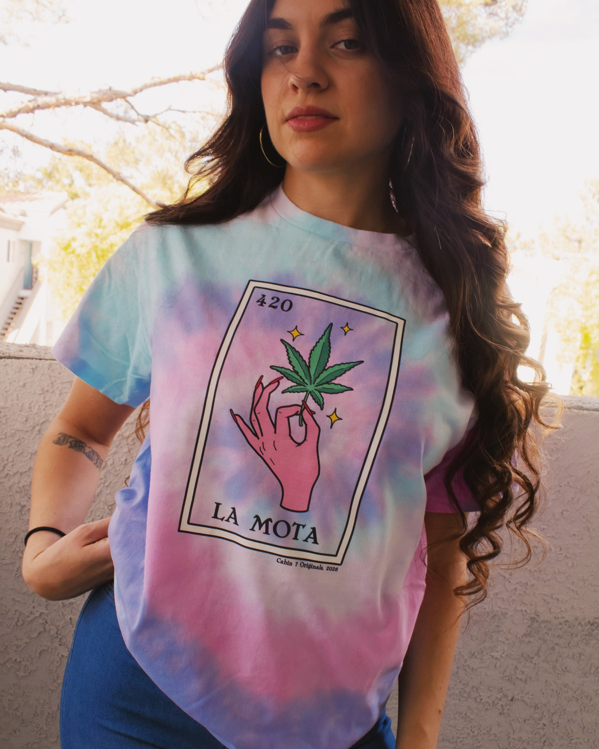 Pink, purple, and baby blue tie dye t-shirt with "La Mota" loteria card on the front. Cannabis shirts, stoner shirts, hippie girl apparel.