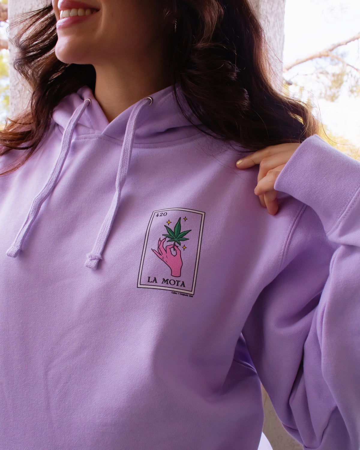 A light purple hoodie featuring a "La Mota" stoner loteria card on front. Stoner hoodie, stoner apparel, hippie apparel.
