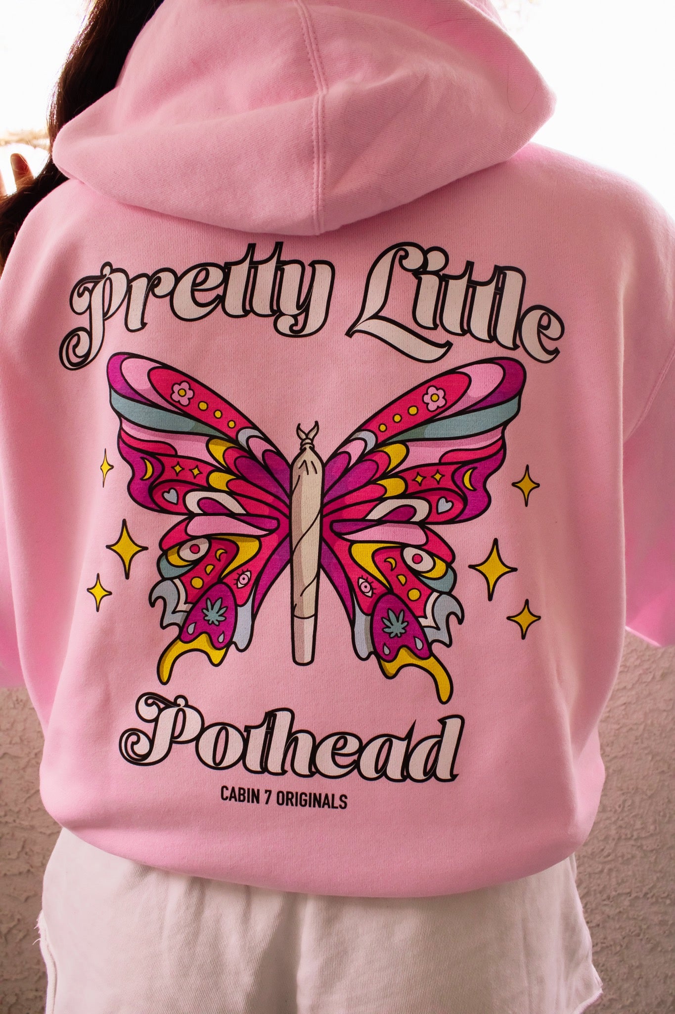A baby pink hoodie with text "Pretty Little Pothead" and a colorful butterfly with a rolled joint as the body. Hippie girl apparel, stoner girl hoodie, 420 hoodie.