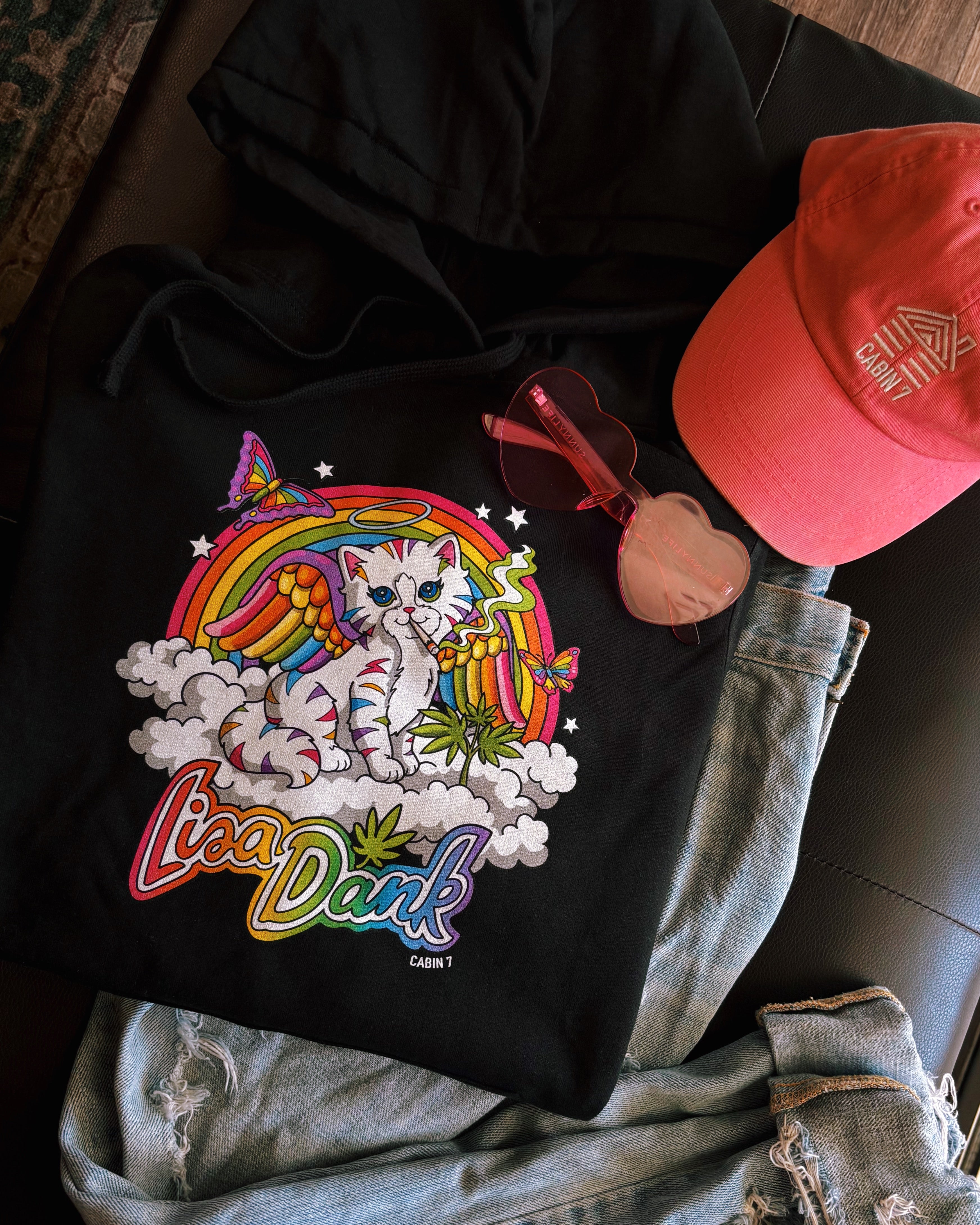 A black hoodie with a colorful stoner Lisa Frank style design, featuring a kitten with angel wings, a rainbow, and a weed plant. Text says "Lisa Dank". Hippie hoodie, stoner hoodie, 420 hoodie.
