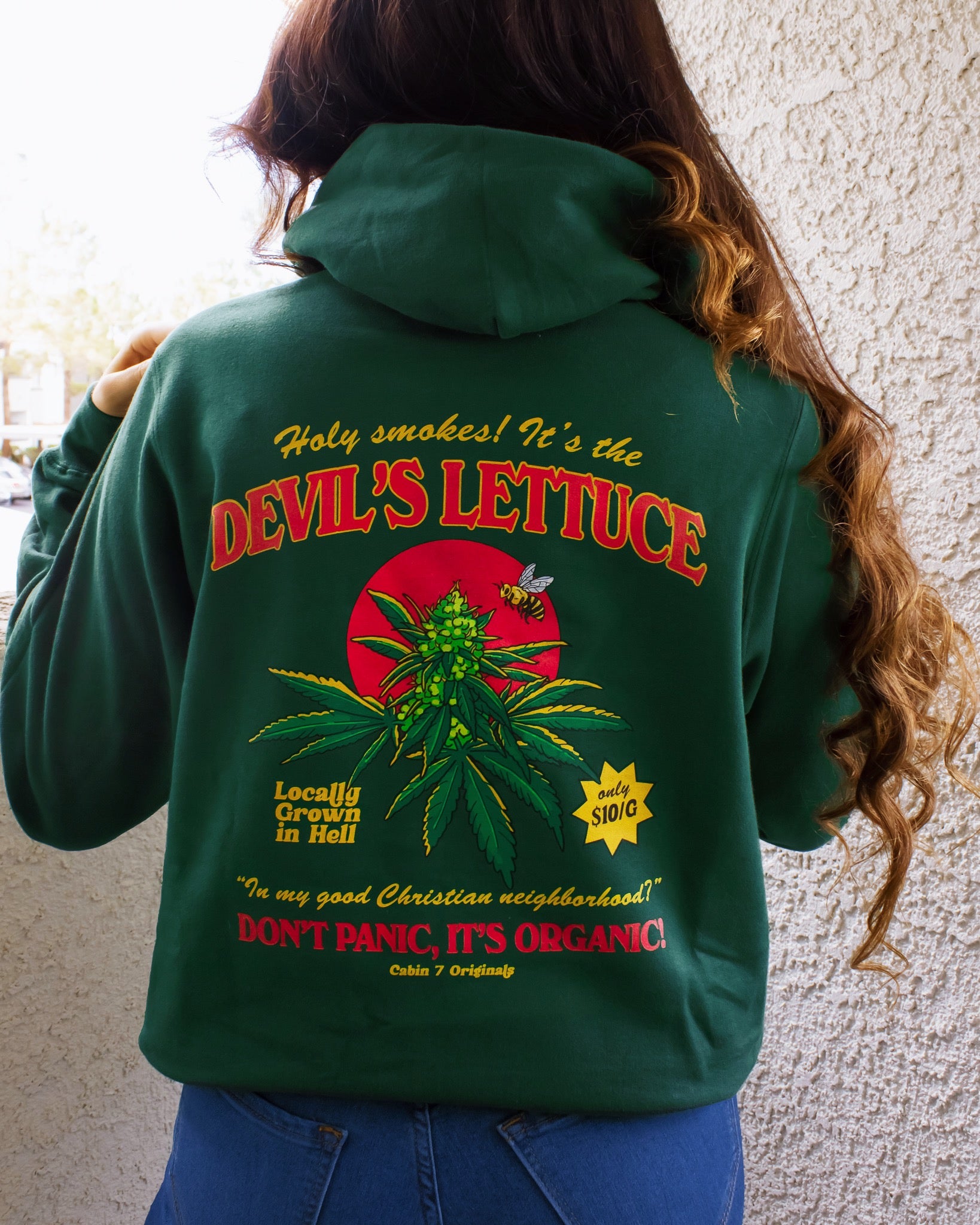 A dark green hoodie with a bright red and gold design of a cannabis plant that says "Devil's Lettuce". Hippie hoodie, 420 hoodie, stoner hoodie.