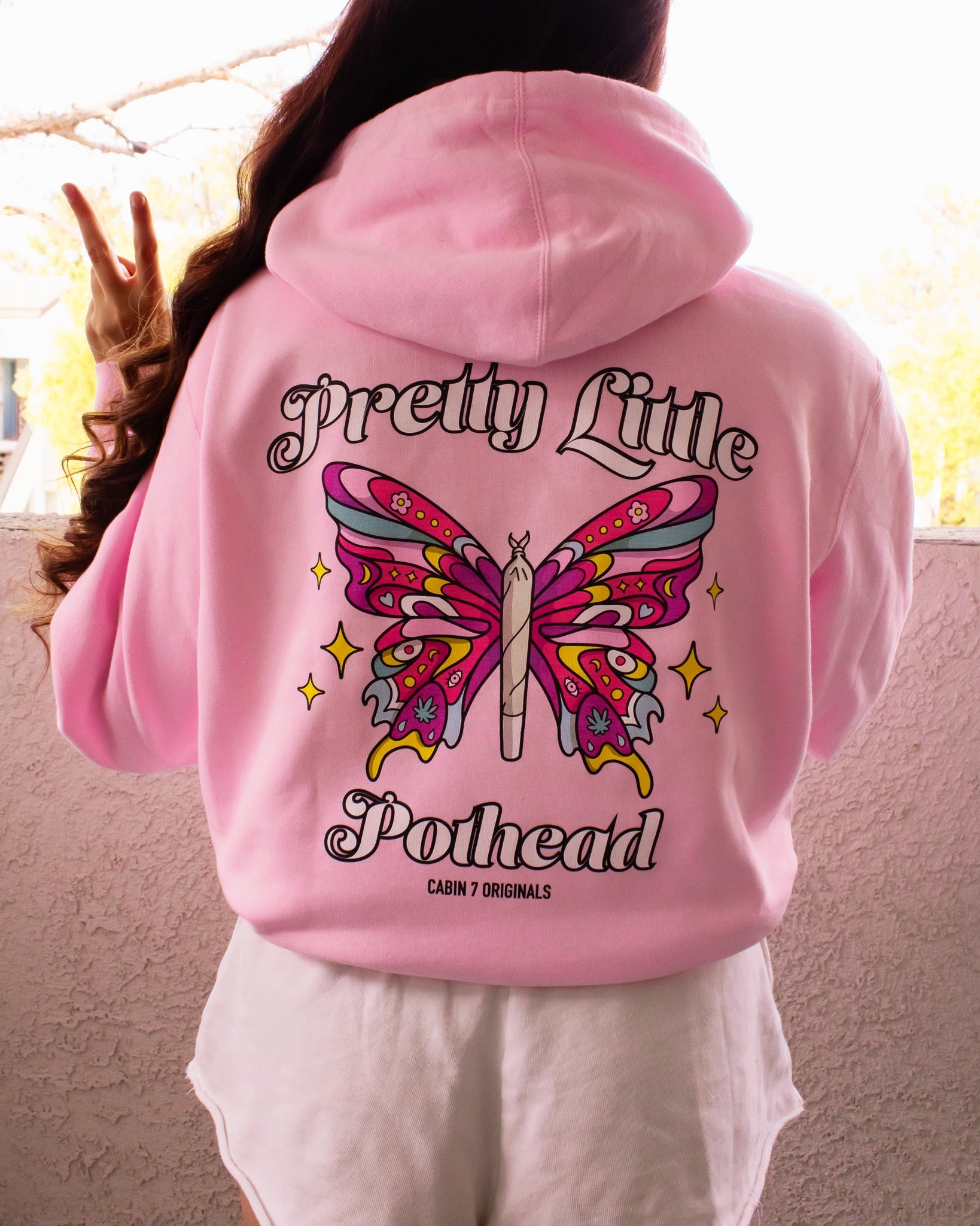 A baby pink hoodie with text "Pretty Little Pothead" and a colorful butterfly with a rolled joint as the body. Hippie girl apparel, stoner girl hoodie, 420 hoodie.