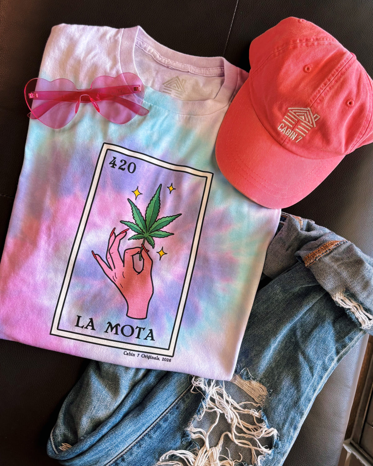 Pink, purple, and baby blue tie dye t-shirt with "La Mota" loteria card on the front. Cannabis shirts, stoner shirts, hippie girl apparel.