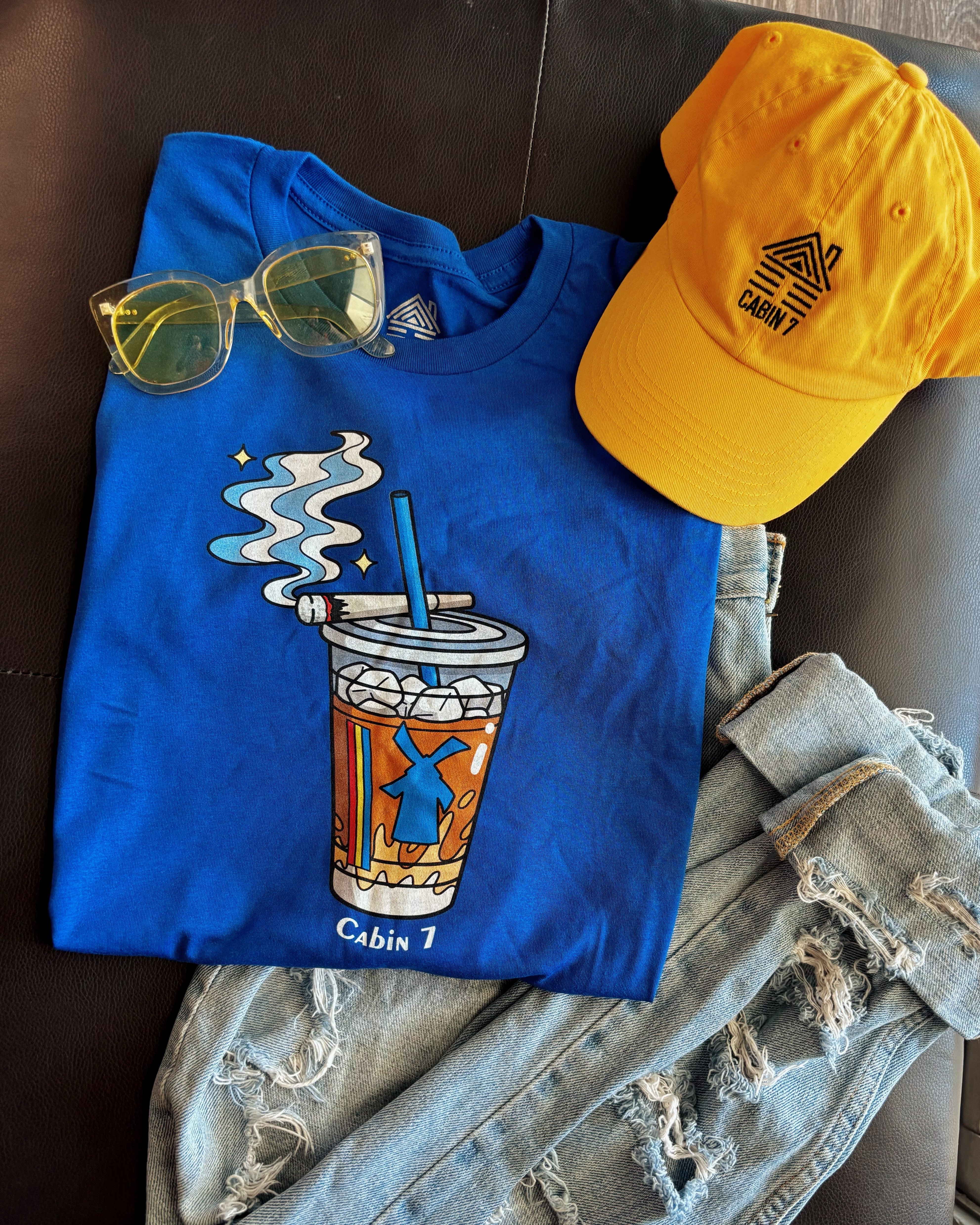 A cobalt blue graphic Dutchie Bros long sleeve shirt with graphic showing a Dutch Bros Coffee cup with smoke and the text 'Cabin 7'.