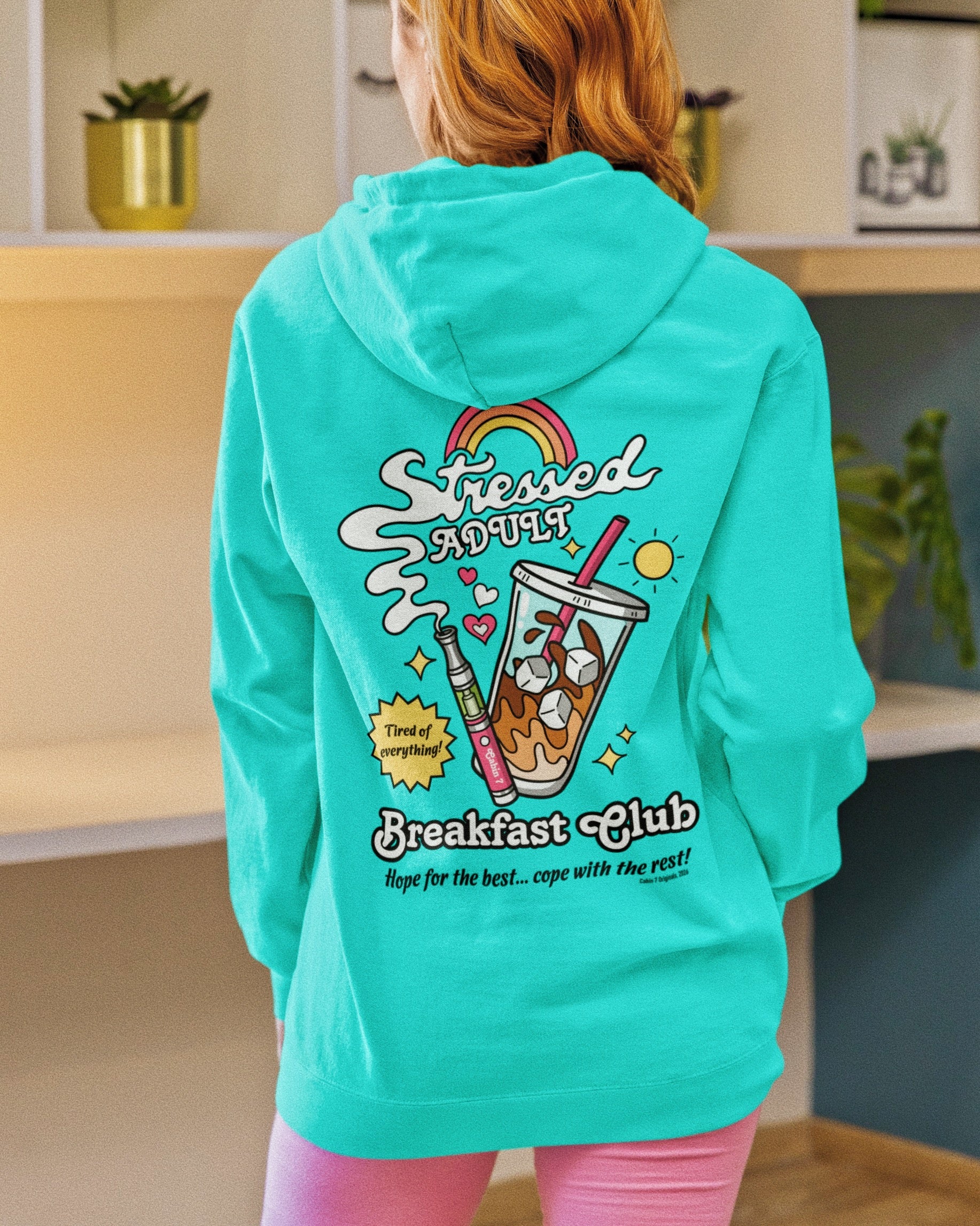 A mint-turquoise hoodie with a brightly colored design with an iced coffee and a cannabis vape pen, reading "Stressed Adult Breakfast Club". Hippie hoodie, 420 hoodie, stoner apparel.