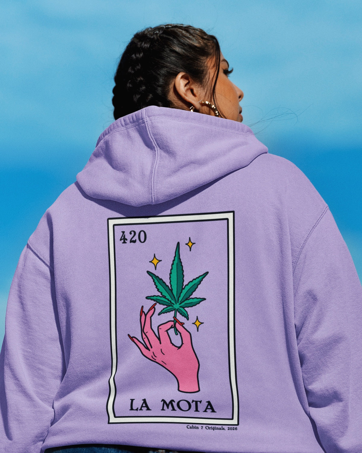 A light purple hoodie featuring a "La Mota" stoner loteria card on back. Stoner hoodie, stoner apparel, hippie apparel.