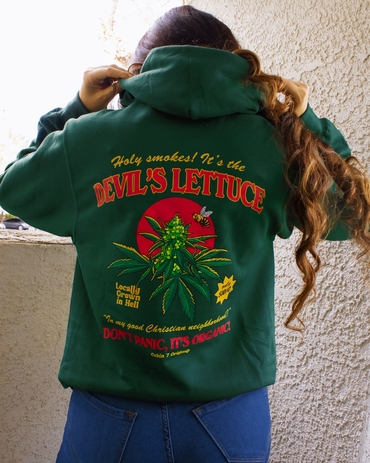 A dark green hoodie with a bright red and gold design of a cannabis plant that says "Devil's Lettuce". Hippie hoodie, 420 hoodie, stoner hoodie.