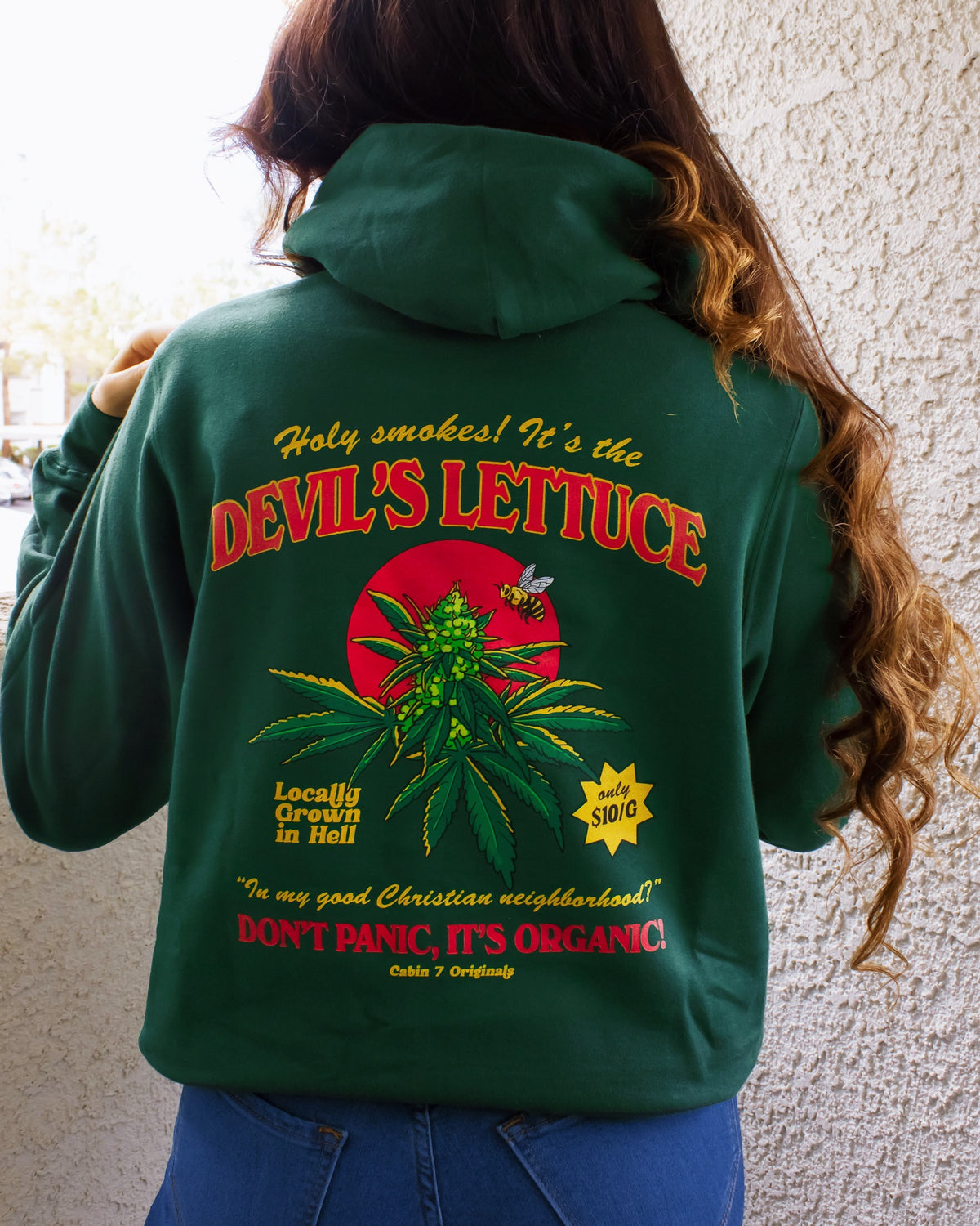 A dark green hoodie with a bright red and gold design of a cannabis plant that says "Devil's Lettuce". Hippie hoodie, 420 hoodie, stoner hoodie.
