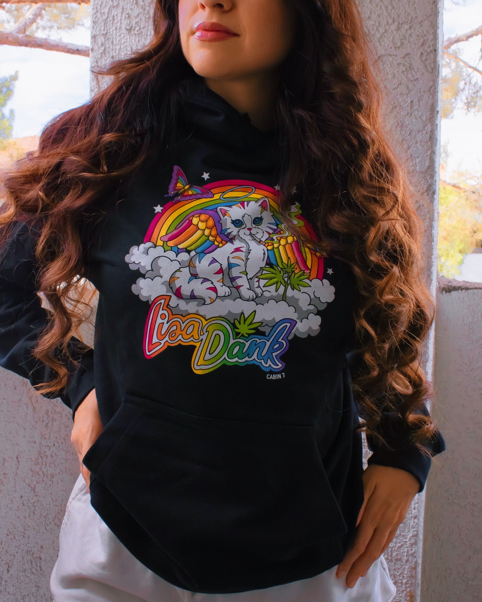 A black hoodie with a colorful stoner Lisa Frank style design, featuring a kitten with angel wings, a rainbow, and a weed plant. Text says "Lisa Dank". Hippie hoodie, stoner hoodie, 420 hoodie.
