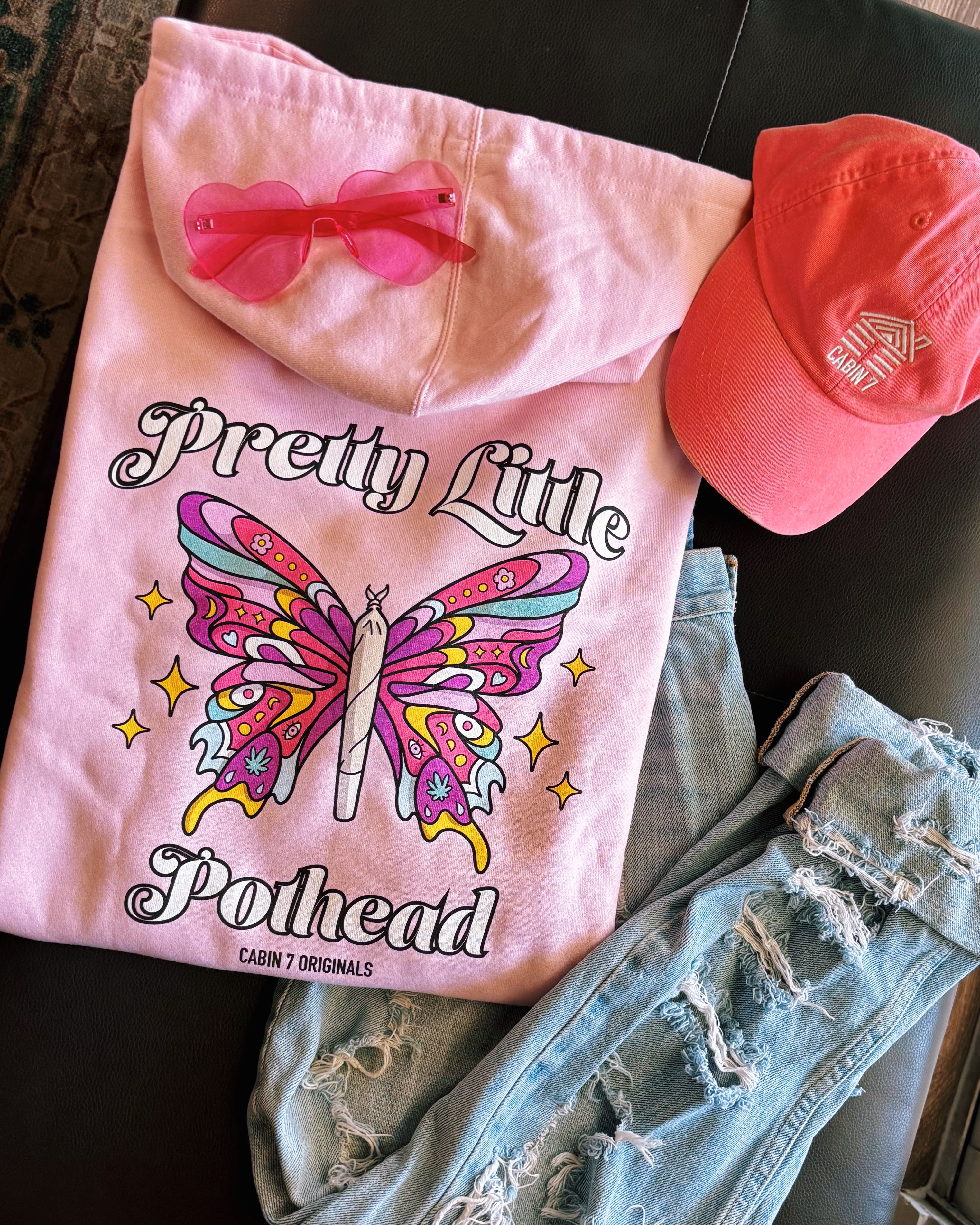 A baby pink hoodie with text "Pretty Little Pothead" and a colorful butterfly with a rolled joint as the body. Hippie girl apparel, stoner girl hoodie, 420 hoodie.