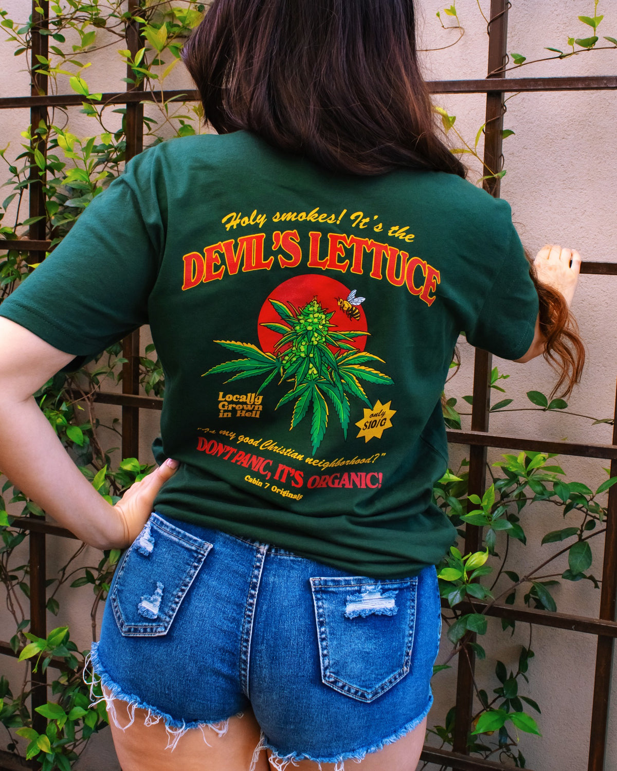 Back of green Cabin 7 cotton t-shirt with 'Devil's Lettuce, Don’t Panic, It’s Organic’ graphic. 