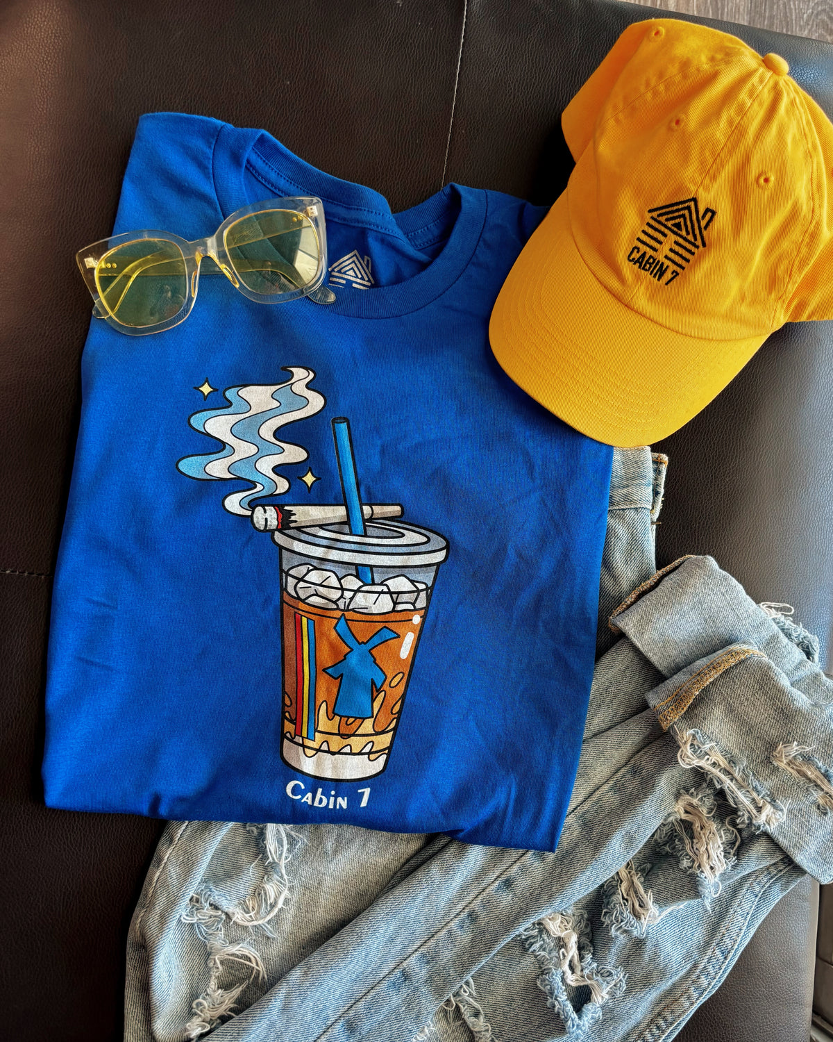 A cobalt blue graphic Dutchie Bros long sleeve shirt with graphic showing a Dutch Bros Coffee cup with smoke and the text 'Cabin 7'.