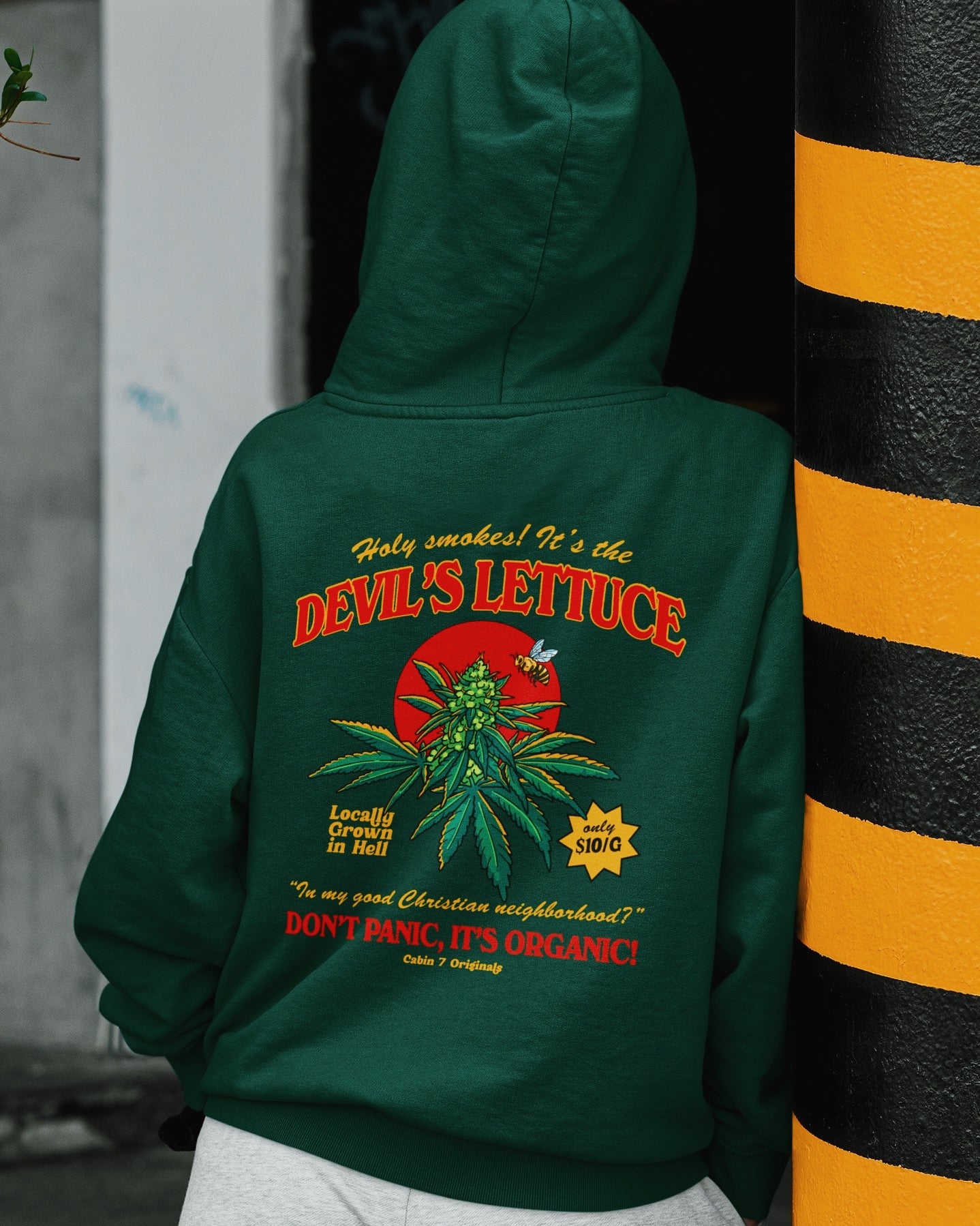 A dark green hoodie with a bright red and gold design of a cannabis plant that says "Devil's Lettuce". Hippie hoodie, 420 hoodie, stoner hoodie.