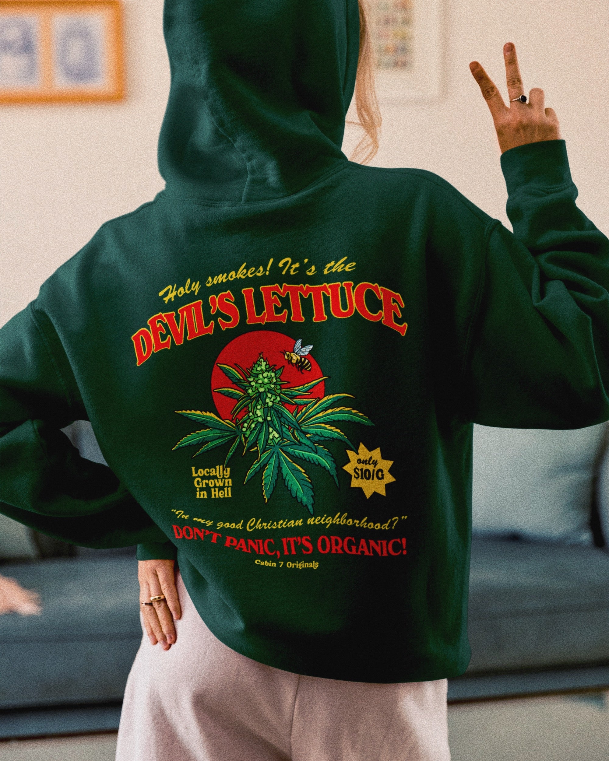 A dark green hoodie with a bright red and gold design of a cannabis plant that says "Devil's Lettuce". Hippie hoodie, 420 hoodie, stoner hoodie.
