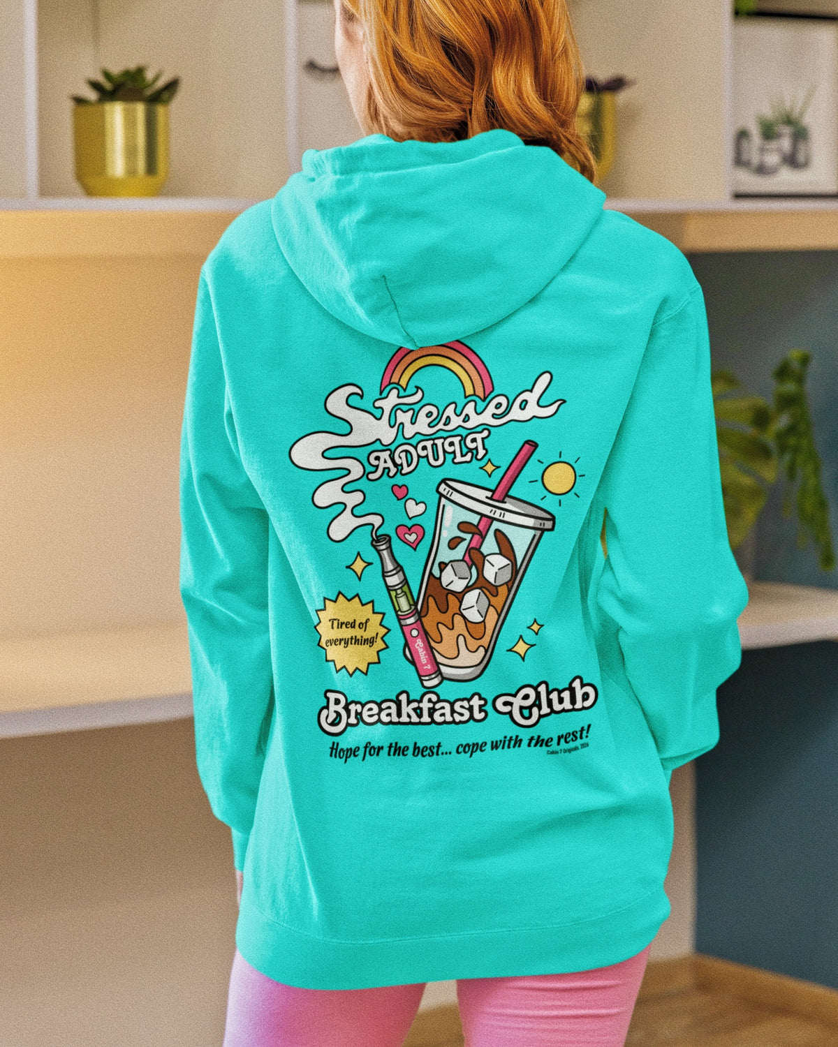 A mint-turquoise hoodie with a brightly colored design with an iced coffee and a cannabis vape pen, reading "Stressed Adult Breakfast Club". Hippie hoodie, 420 hoodie, stoner apparel.