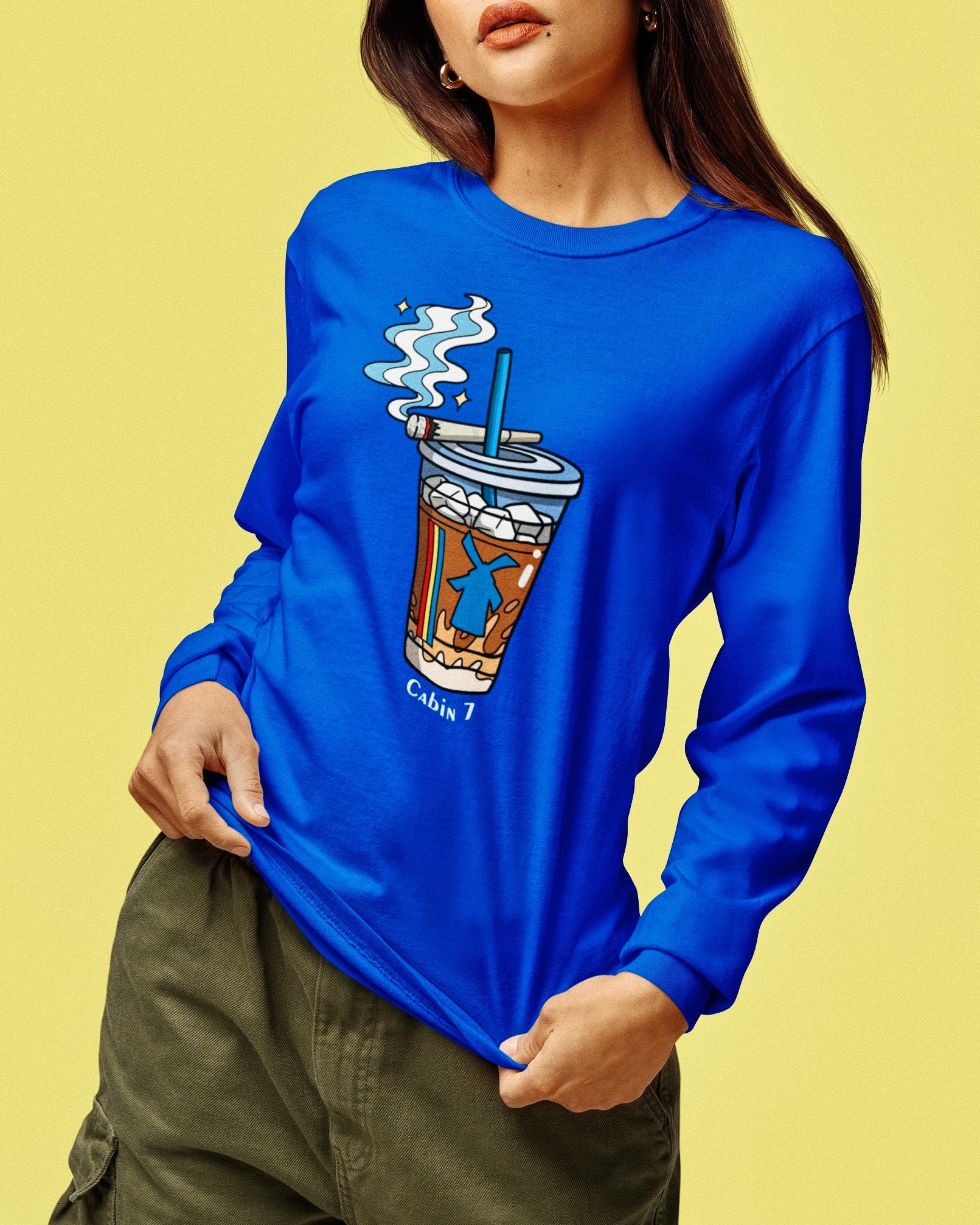 A cobalt blue graphic Dutchie Bros long sleeve shirt with graphic showing a Dutch Bros Coffee cup with smoke and the text 'Cabin 7'.