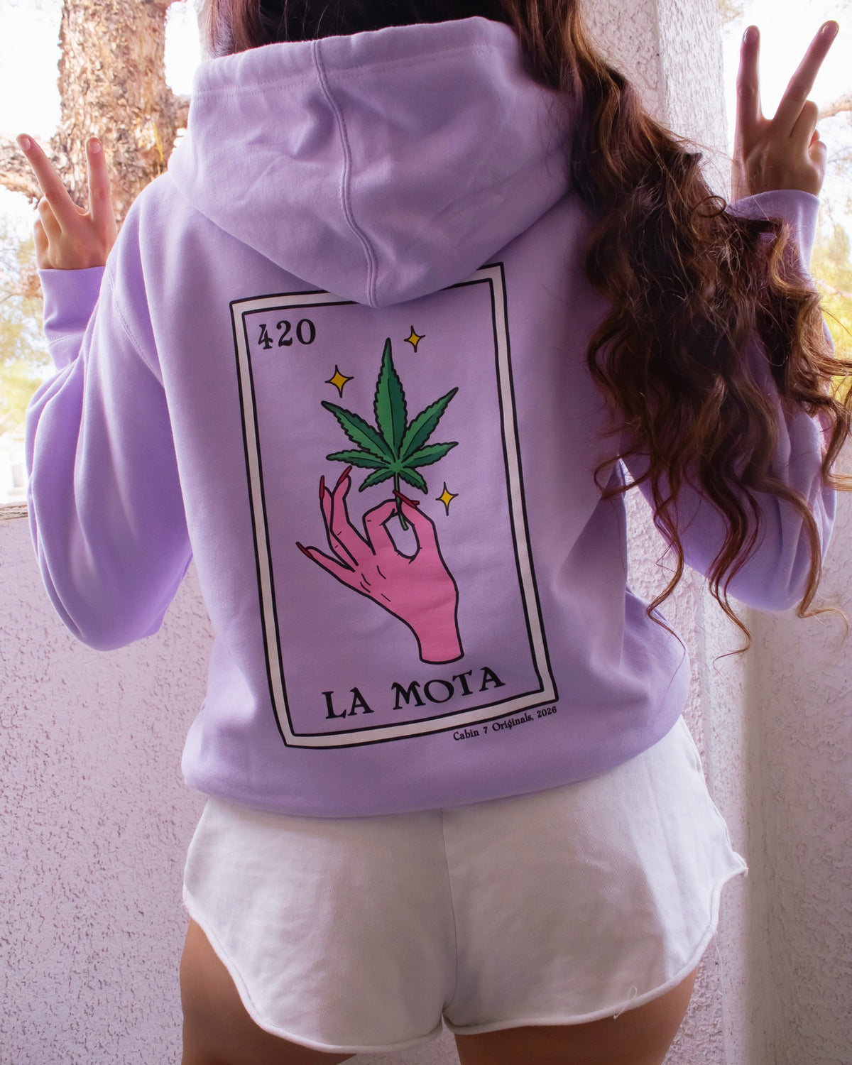A light purple hoodie featuring a "La Mota" stoner loteria card on back. Stoner hoodie, stoner apparel, hippie apparel.