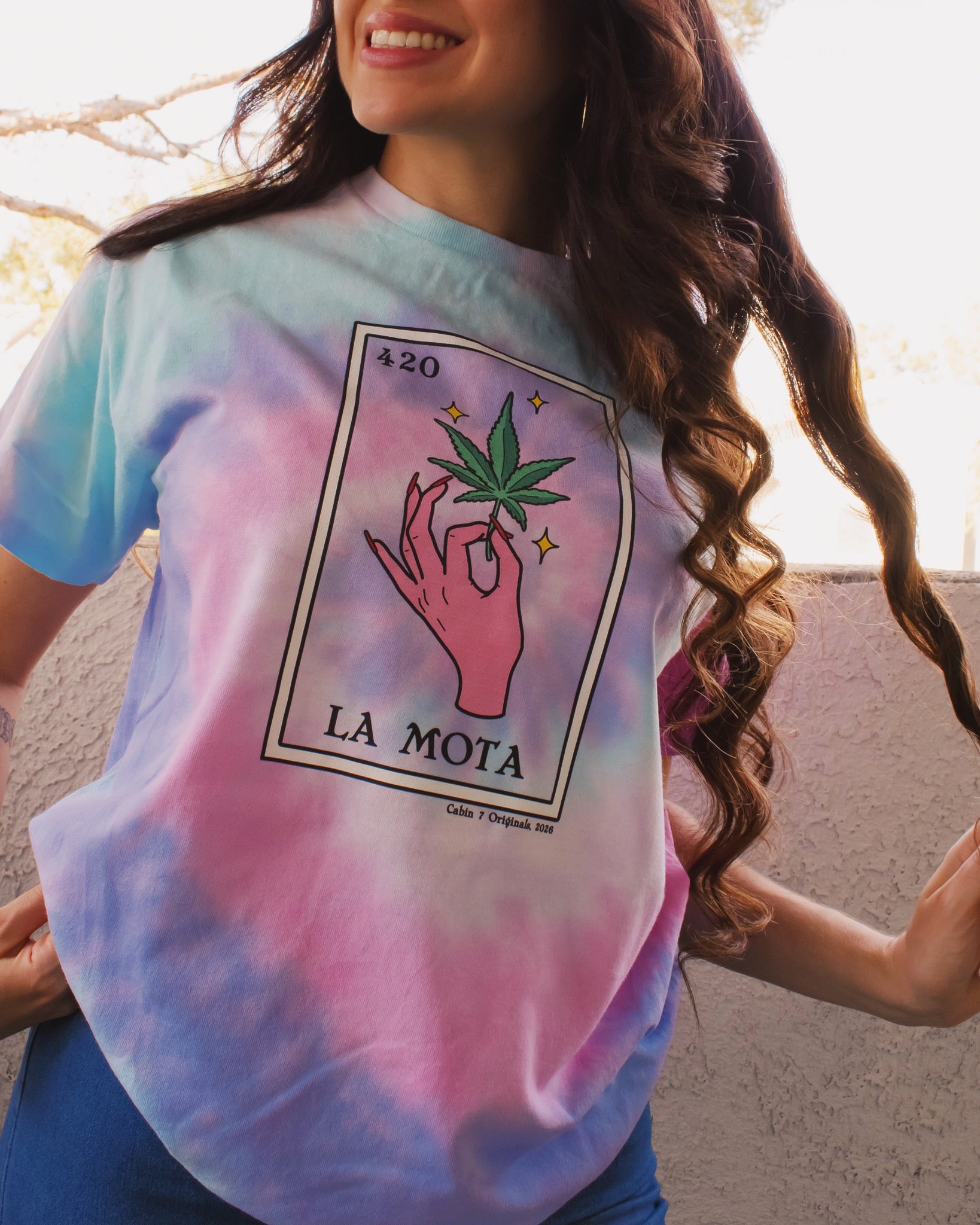 Pink, purple, and baby blue tie dye t-shirt with "La Mota" loteria card on the front. Cannabis shirts, stoner shirts, hippie girl apparel.